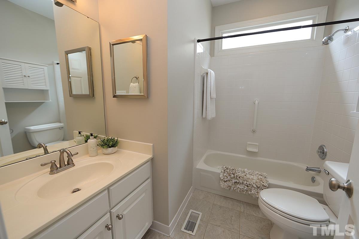 6317 Belle Crest Drive Raleigh, NC 27612 - Photo 18 of 29 a bathroom with a sink toilet and shower