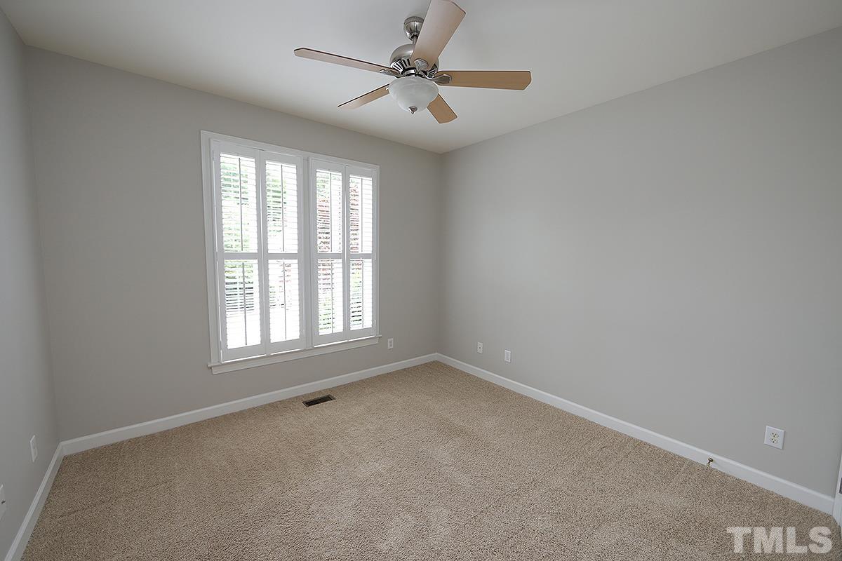 6317 Belle Crest Drive Raleigh, NC 27612 - Photo 19 of 29 an empty room with a window and a fan