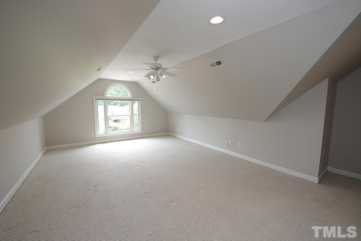 6317 Belle Crest Drive Raleigh, NC 27612 - Photo 20 of 29 an empty room with windows and chandelier fan