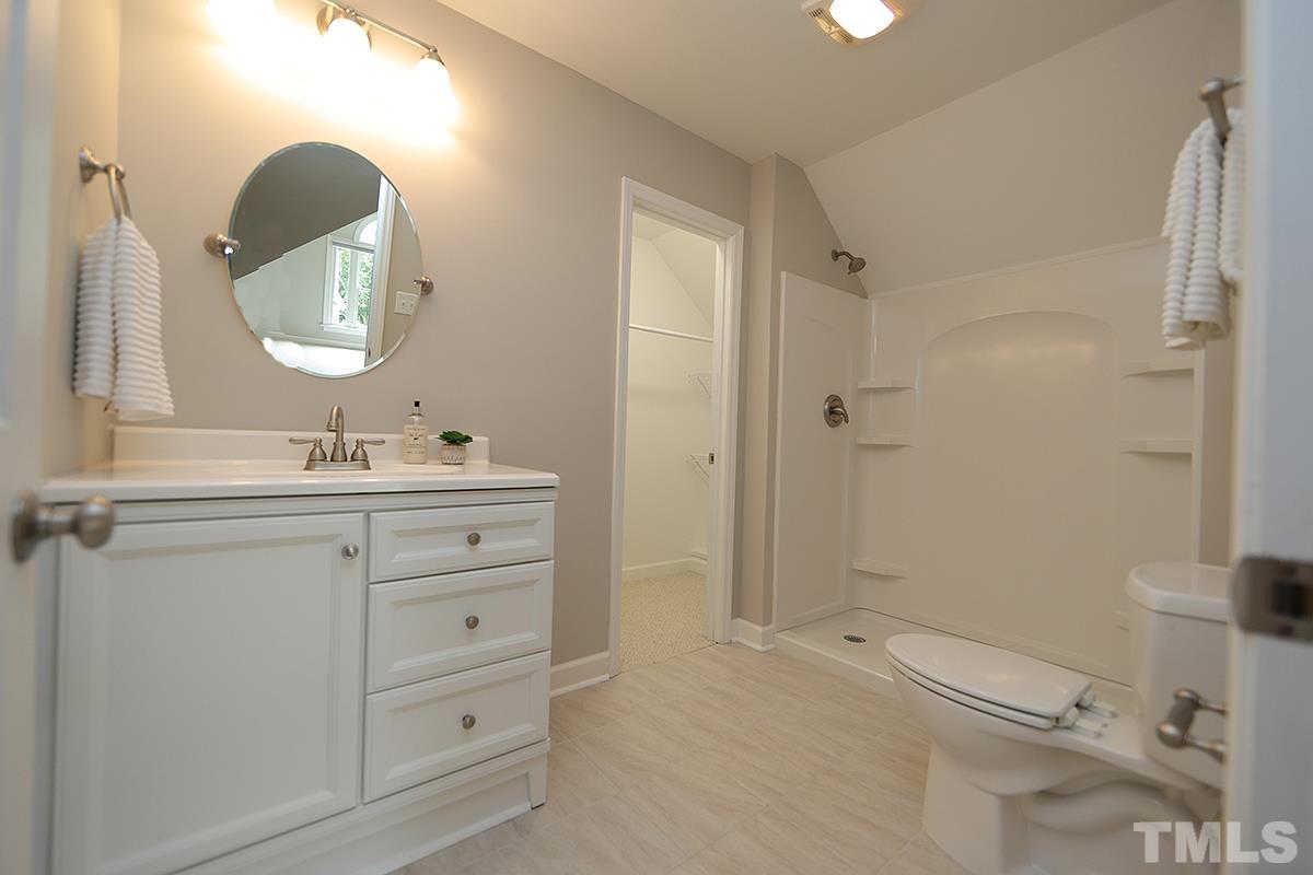 6317 Belle Crest Drive Raleigh, NC 27612 - Photo 21 of 29 a bathroom with a double vanity sink mirror and toilet