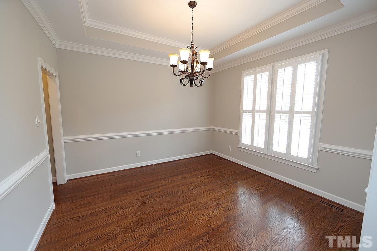 6317 Belle Crest Drive Raleigh, NC 27612 - Photo 10 of 29 a view of an empty room with wooden floor and a window