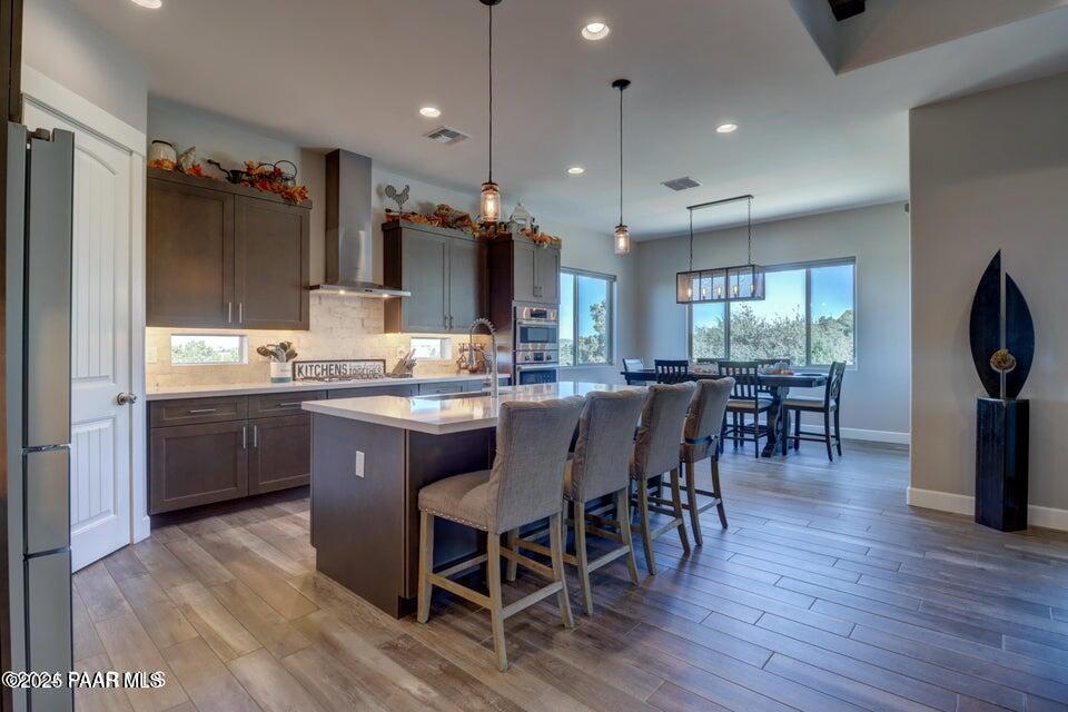 5505 Corliss Circle Prescott, AZ 86305 - Photo 4 of 12 a kitchen with a dining table chairs and refrigerator