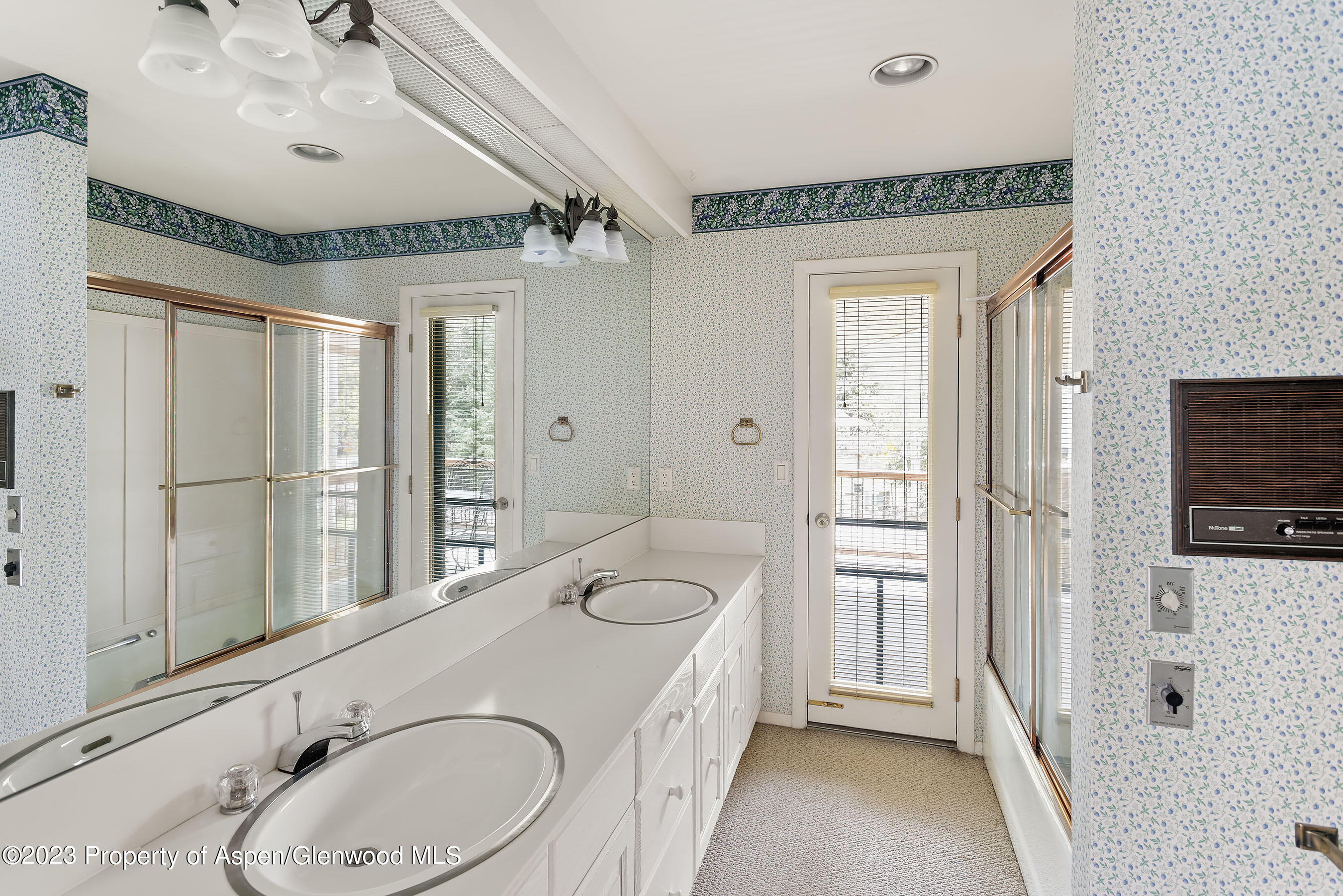 800 Bonita Drive, Unit 1 Aspen, CO 81611 - Photo 11 of 18 a bathroom with a granite countertop double vanity sink a mirror and a bathtub
