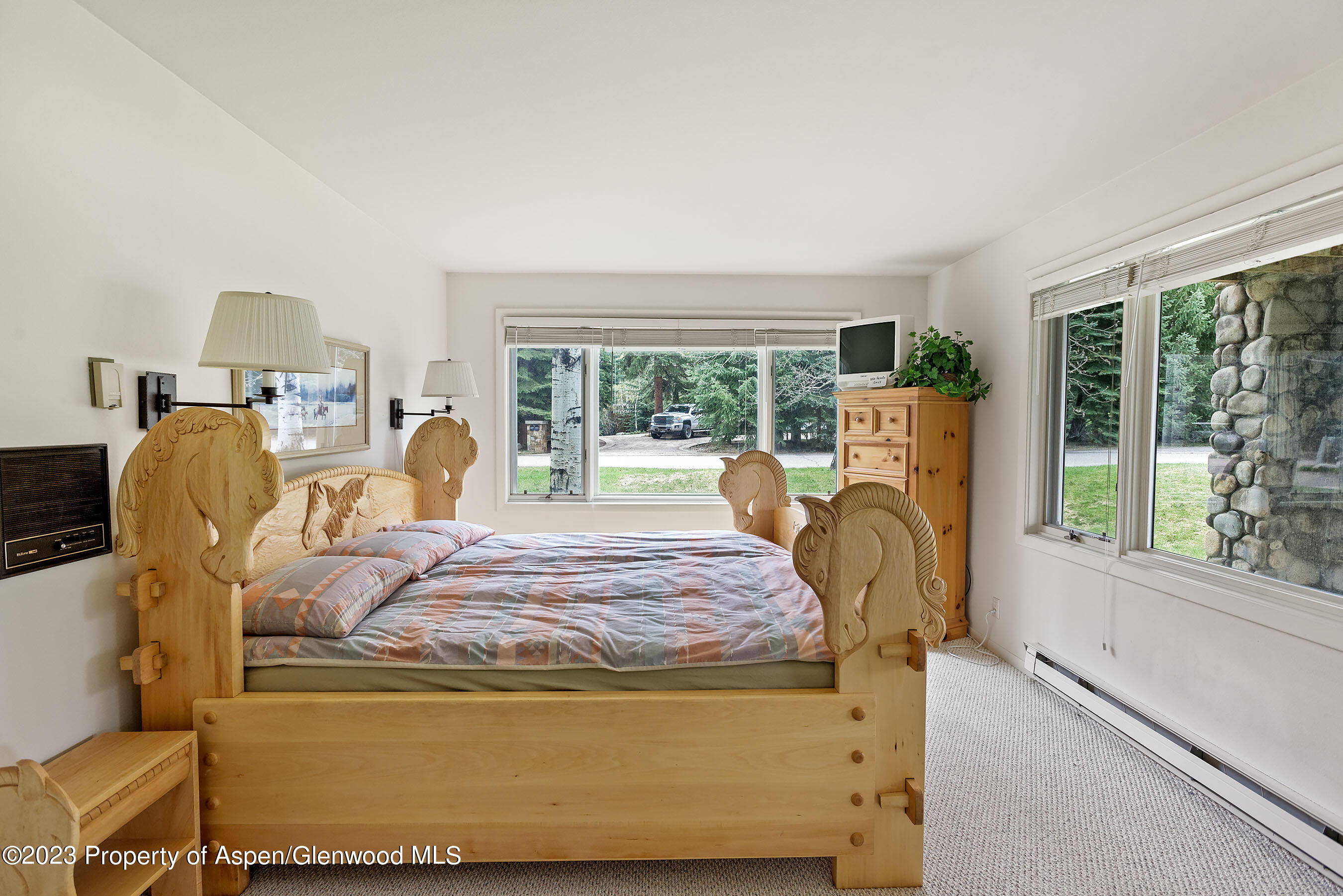 800 Bonita Drive, Unit 1 Aspen, CO 81611 - Photo 14 of 18 a bed sitting in a bedroom next to a window