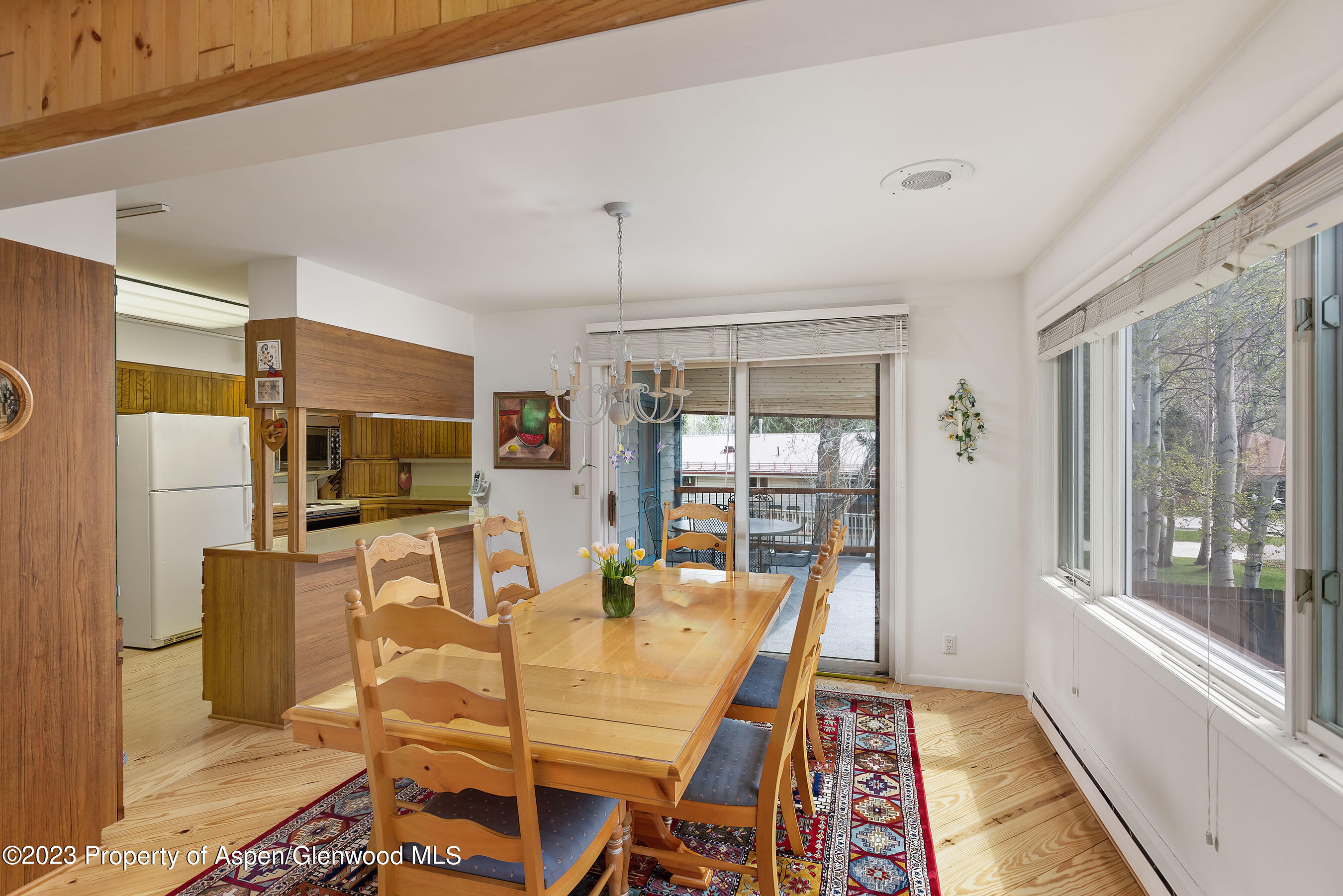 800 Bonita Drive, Unit 1 Aspen, CO 81611 - Photo 7 of 18 a dining room with furniture and large windows