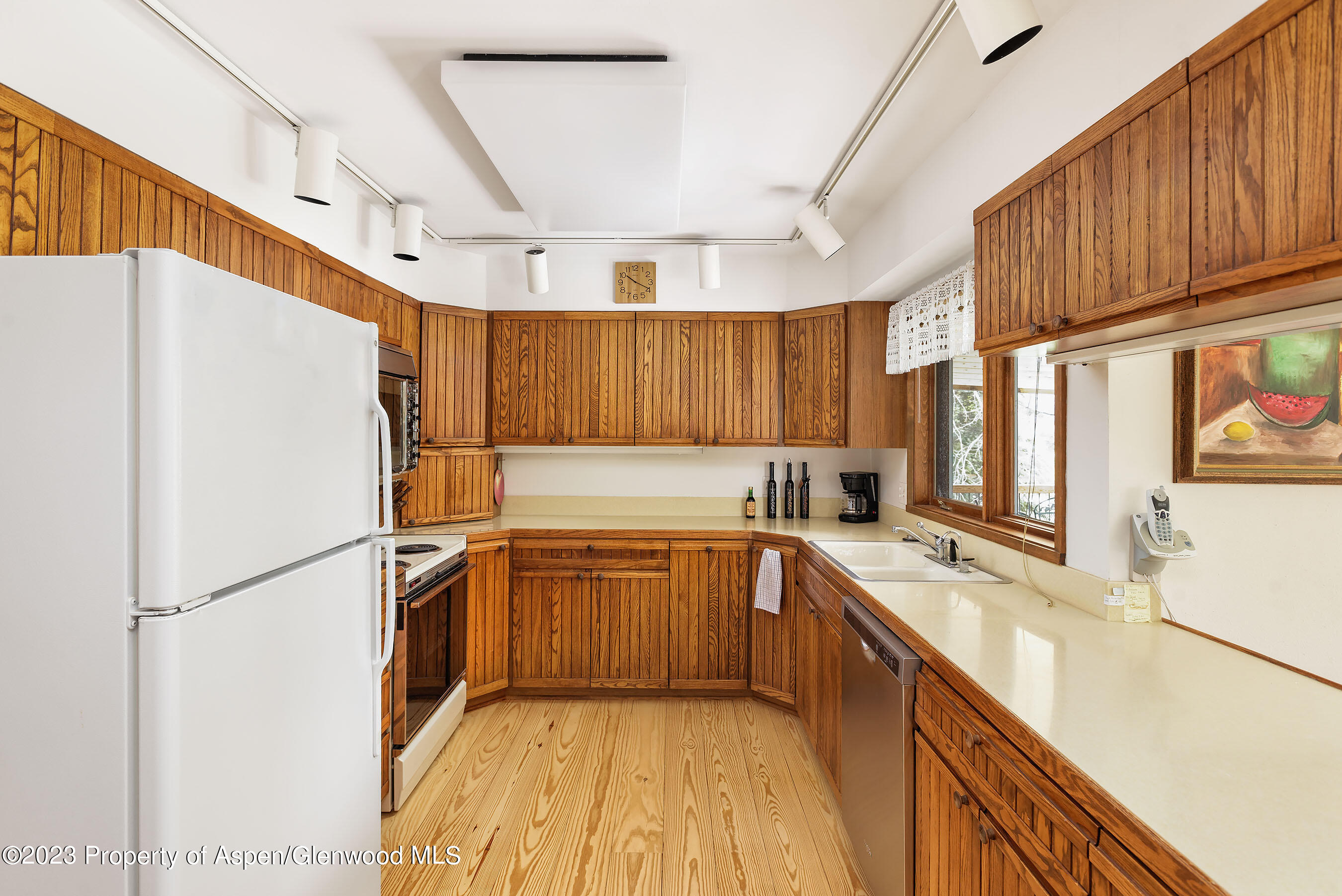 800 Bonita Drive, Unit 1 Aspen, CO 81611 - Photo 8 of 18 a kitchen with stainless steel appliances granite countertop a refrigerator a sink dishwasher a stove with wooden cabinets