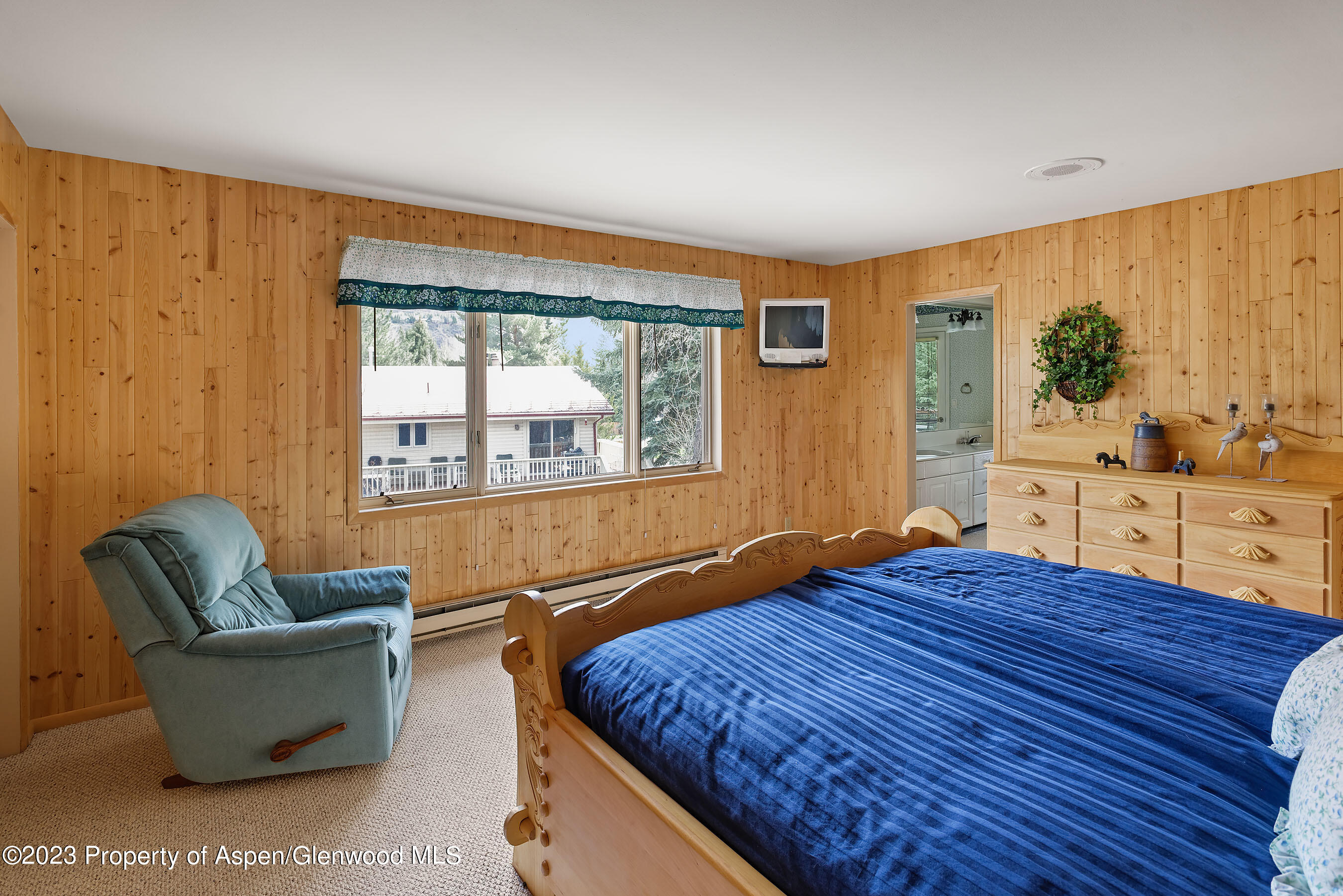 800 Bonita Drive, Unit 1 Aspen, CO 81611 - Photo 10 of 18 a bedroom with a bed and wooden floor