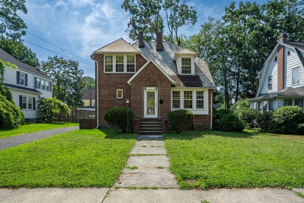 a front view of a house with garden