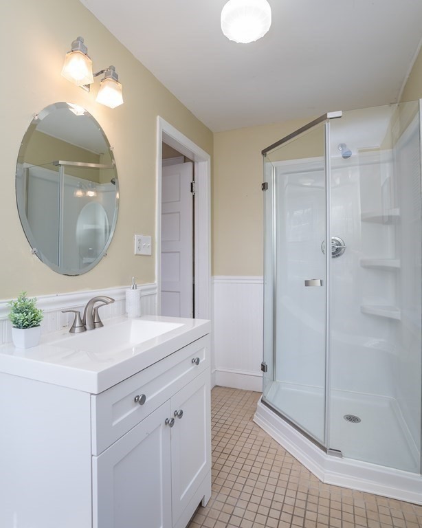 35 Bronson Terrace Springfield, MA 01108 - Photo 29 of 39 a bathroom with a sink a mirror a vanity and shower