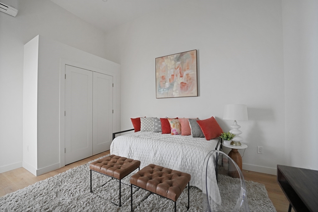 403 Division Street, Unit 17 Fall River, MA 02721 - Photo 14 of 29 a bedroom with a bed and chair