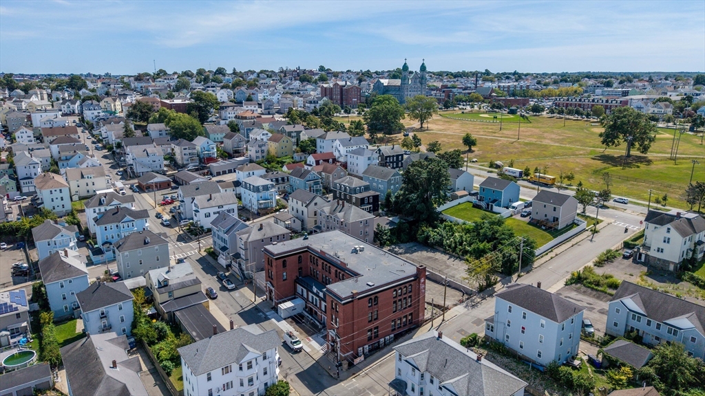 403 Division Street, Unit 17 Fall River, MA 02721 - Photo 22 of 29 an aerial view of a city with lots of residential buildings ocean and mountain view in back
