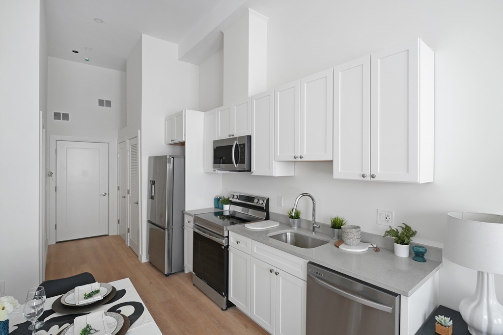 403 Division Street, Unit 17 Fall River, MA 02721 - Photo 7 of 29 a kitchen with cabinets appliances and a counter space