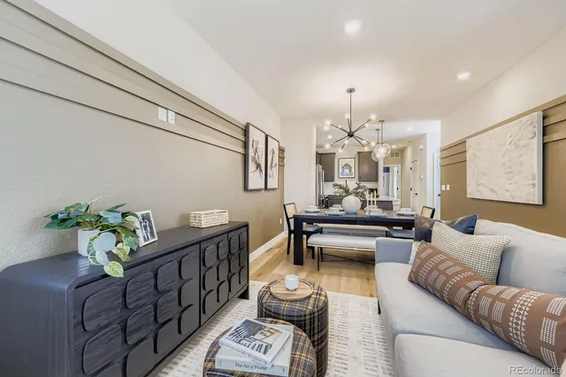a living room with furniture and a chandelier