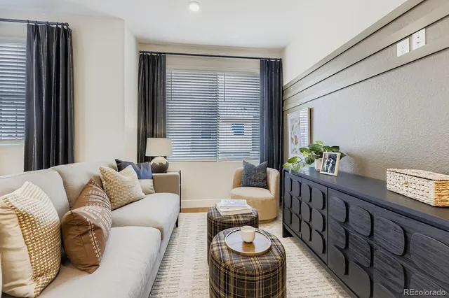 a living room with furniture and a potted plant