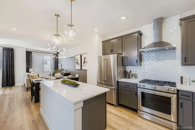 a kitchen with a stove and a wooden floors