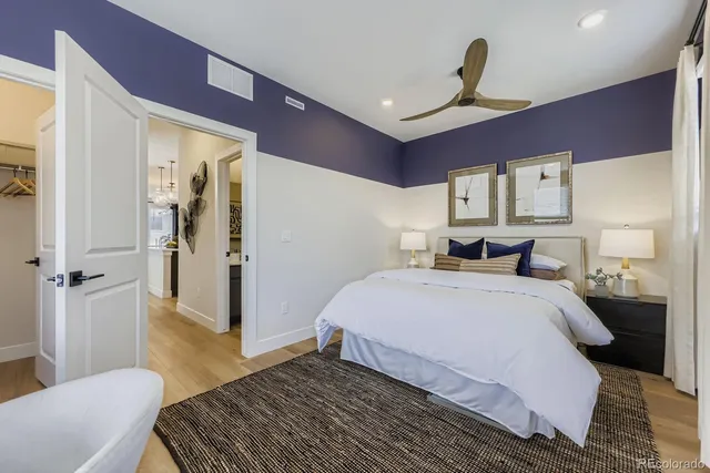 a spacious bedroom with a bed and a dresser