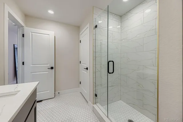 a bathroom with a shower and a sink