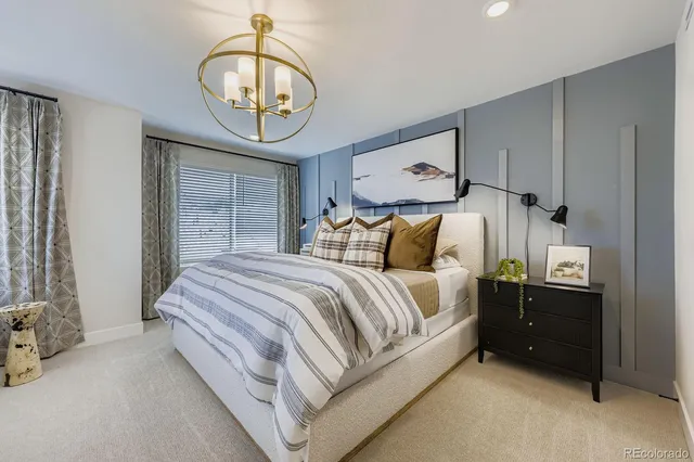 a bedroom with a bed a mirror and a window