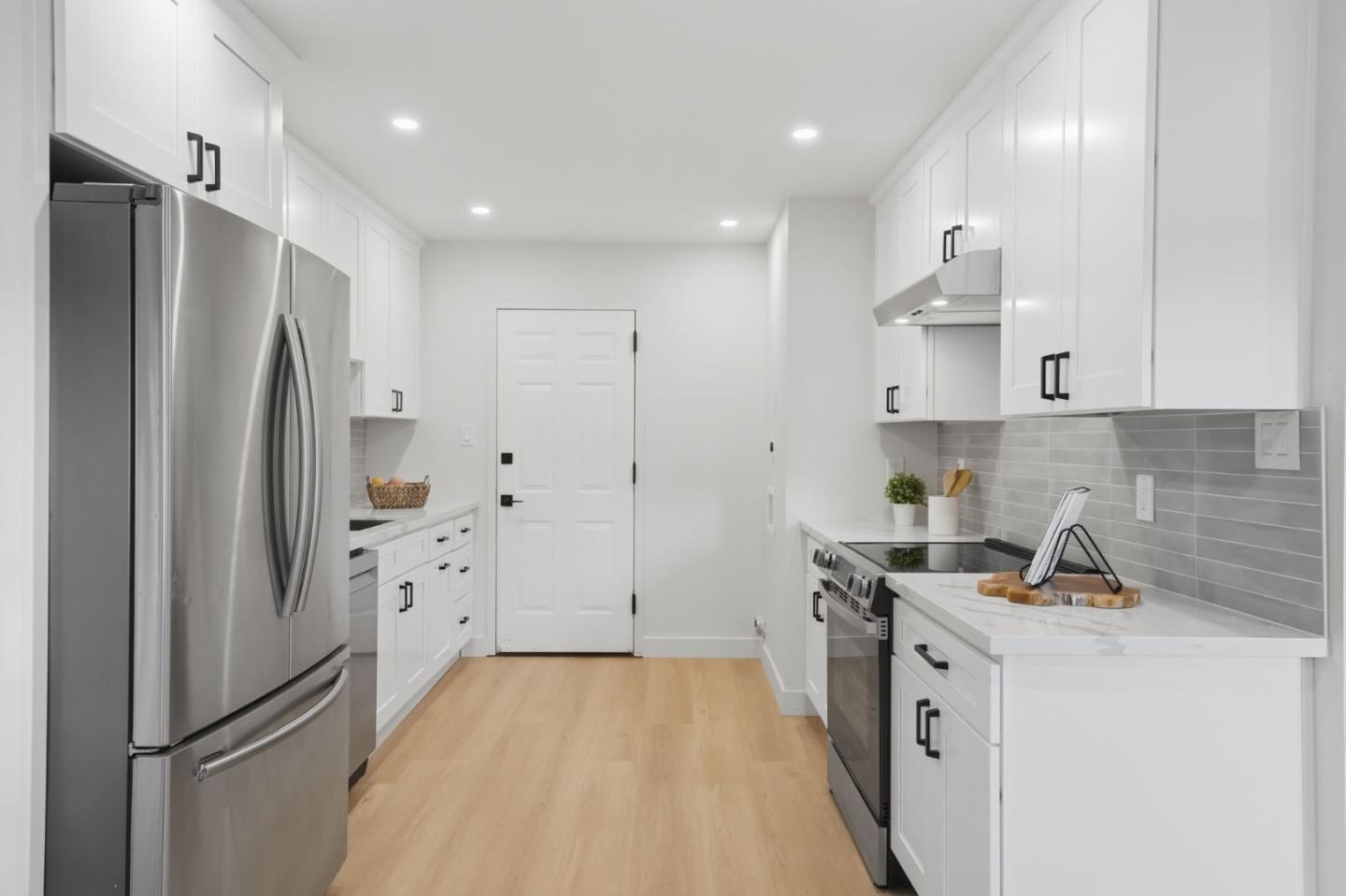 409 Puerto Place Hayward, CA 94541 - Photo 13 of 54 a kitchen with stainless steel appliances a refrigerator a stove and white cabinets