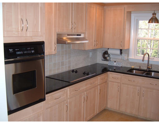 44 Great Road Maynard, MA 01754 - Photo 3 of 19 a kitchen with stainless steel appliances granite countertop a stove a sink and white cabinets