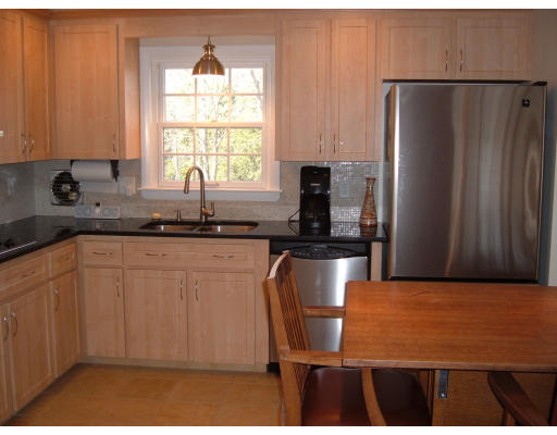 44 Great Road Maynard, MA 01754 - Photo 4 of 19 a kitchen with granite countertop a refrigerator and a sink