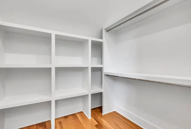 a view of room with wooden floor and cabinets