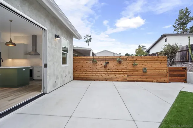 a view of a house with a yard and sitting area