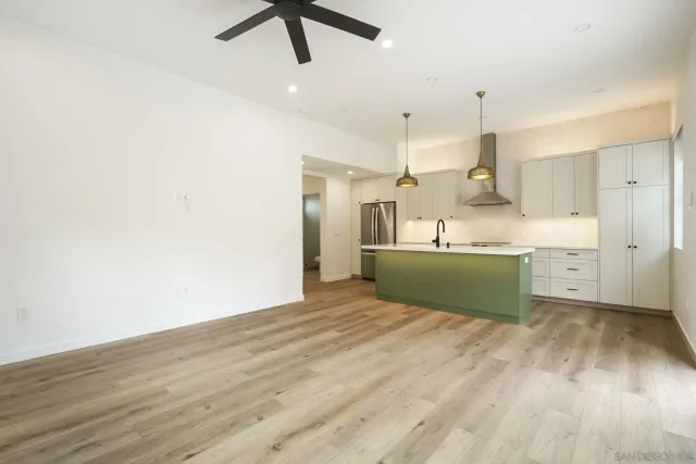 a view of a kitchen with wooden floor