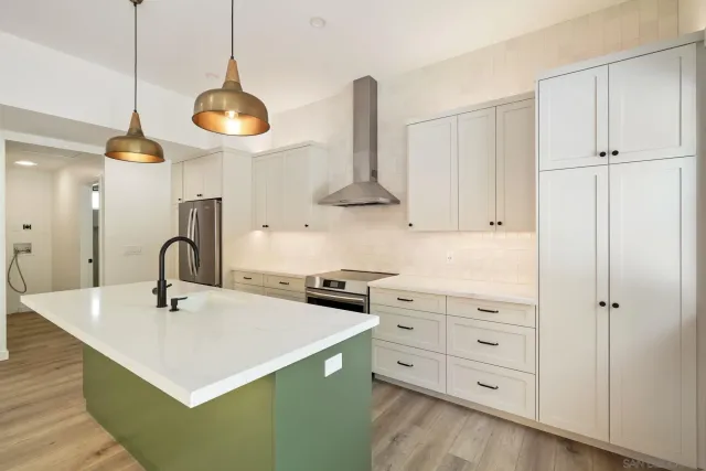 a kitchen with cabinets a sink and appliances