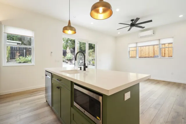 a kitchen with a sink cabinets and window