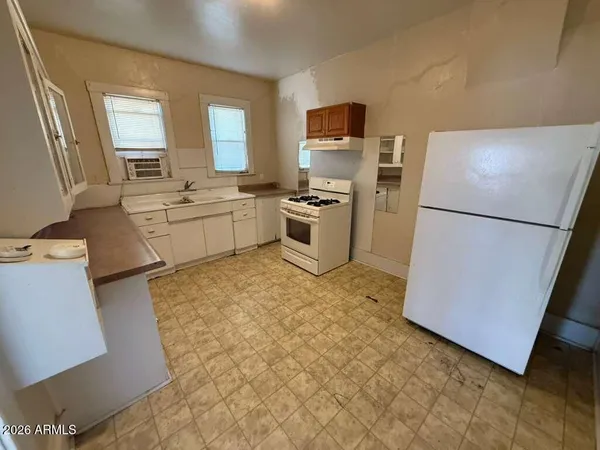 a kitchen with a refrigerator stove and sink