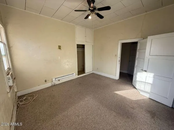 a view of a livingroom with a ceiling fan and window