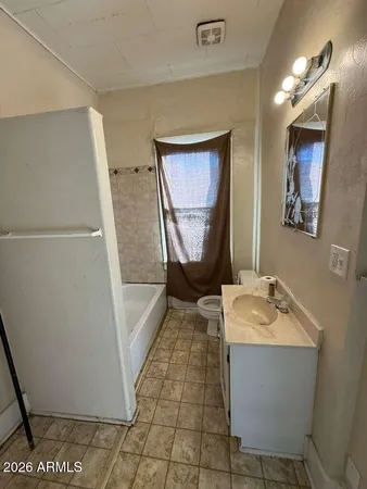 a bathroom with a sink a mirror and a bath tub