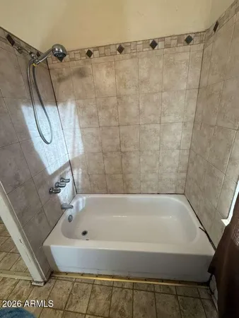 a bathroom with a shower and a bath tub