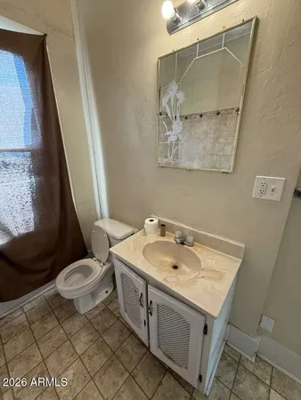 a bathroom with a sink a toilet and a mirror