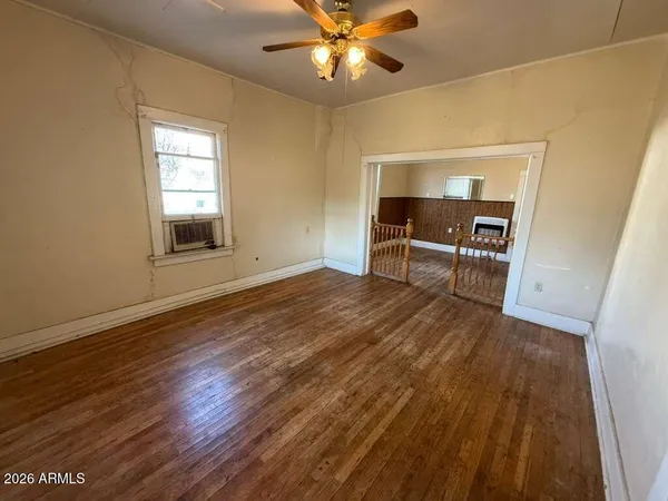 wooden floor in an empty room with a window