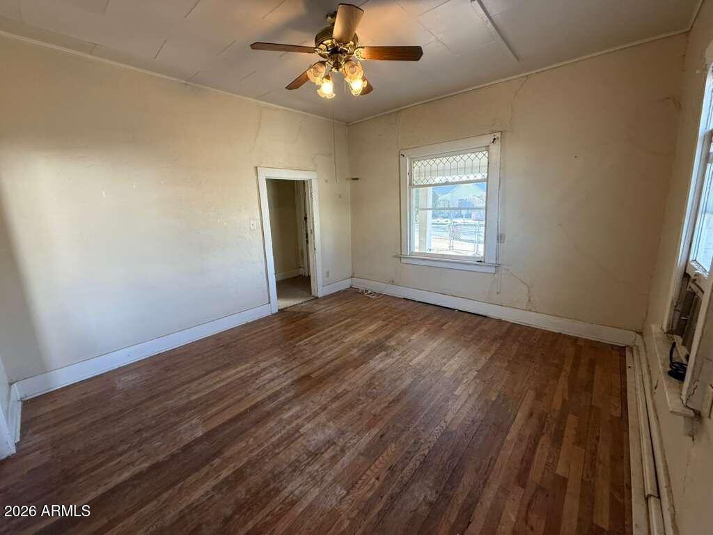 1014 East 14th Street Douglas, AZ 85607 - Photo 9 of 38 a view of an empty room with wooden floor and a window