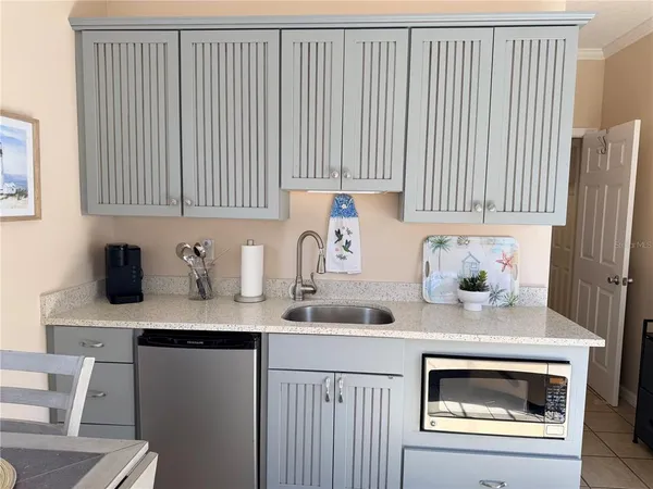 a kitchen with a sink cabinets and window