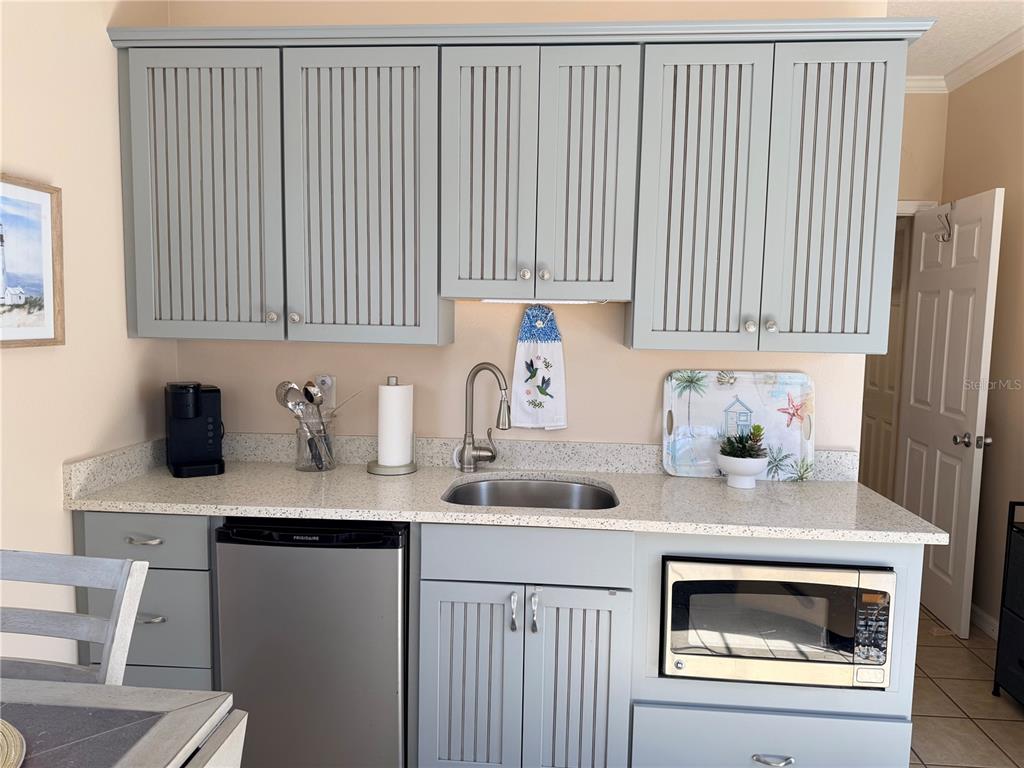 9486 Southeast 47th Way Webster, FL 33597 - Photo 12 of 32 a kitchen with a sink cabinets and window