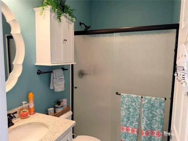 a bathroom with a sink toilet and shower