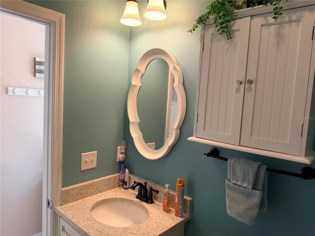 9486 Southeast 47th Way Webster, FL 33597 - Photo 14 of 32 a bathroom with a sink and a mirror