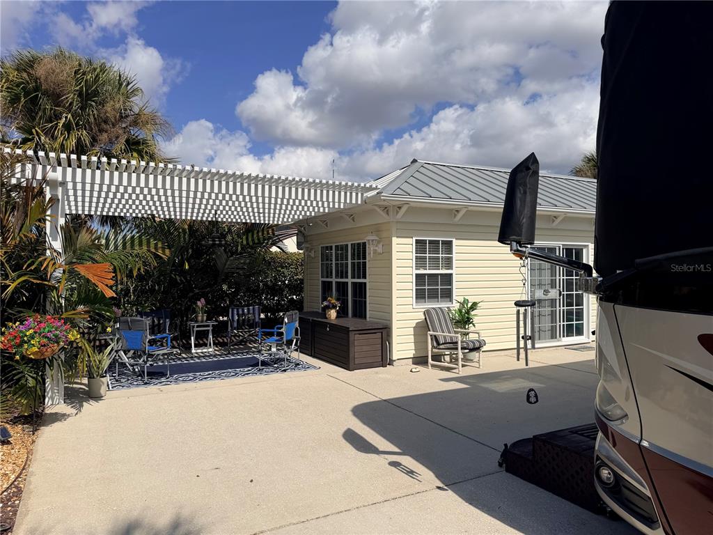 9486 Southeast 47th Way Webster, FL 33597 - Photo 5 of 32 a view of a patio with table and chairs and potted plants