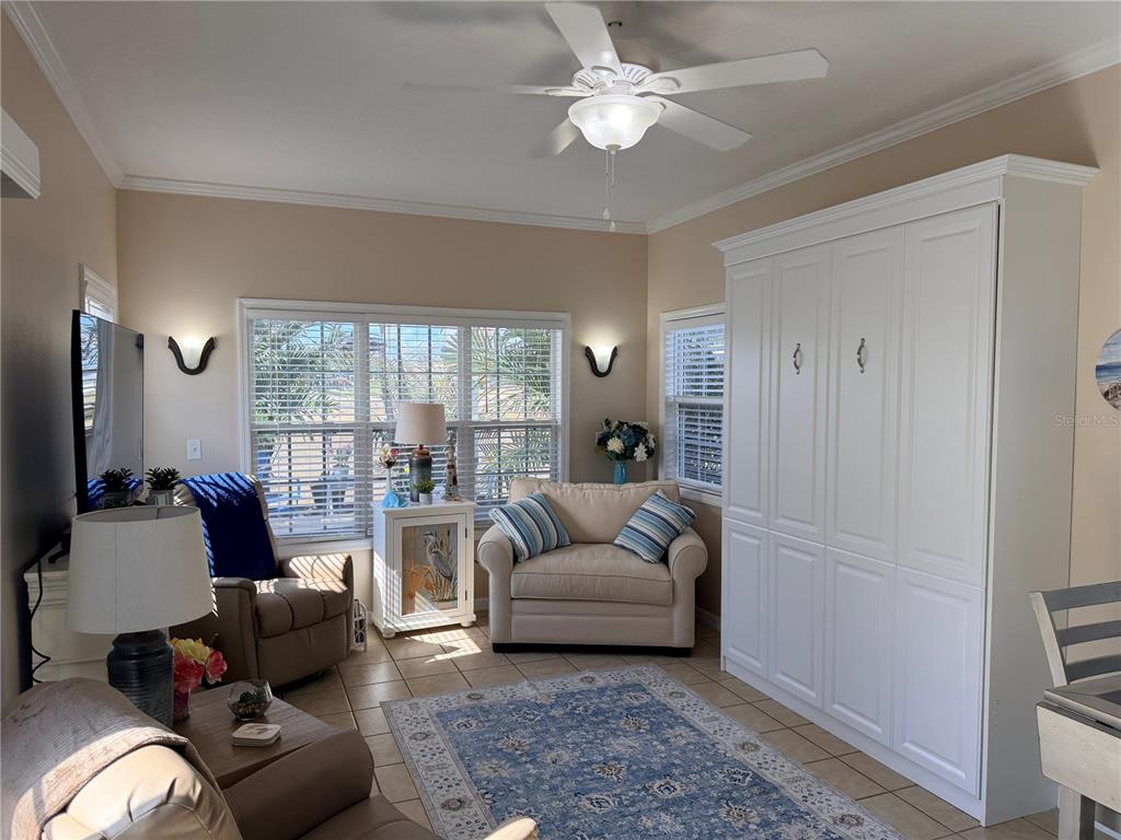 9486 Southeast 47th Way Webster, FL 33597 - Photo 7 of 32 a living room with furniture and a large window