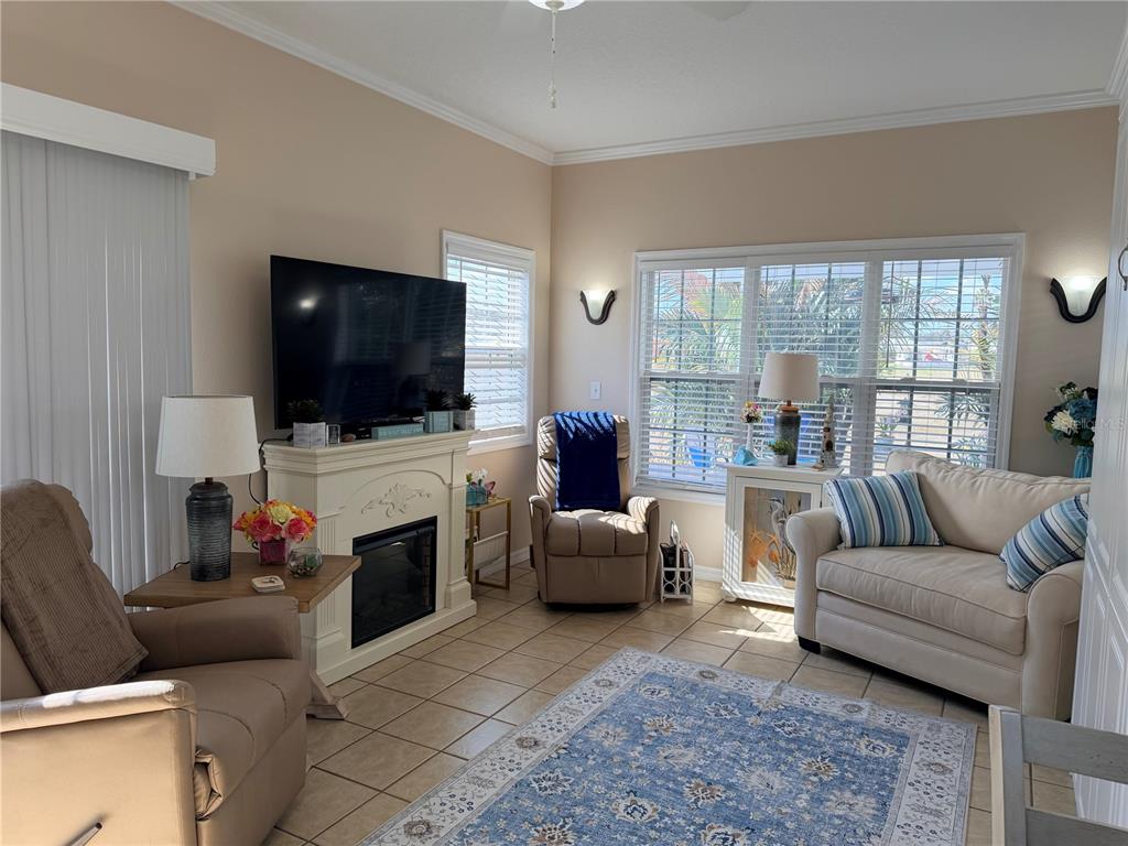 9486 Southeast 47th Way Webster, FL 33597 - Photo 8 of 32 a living room with fireplace furniture and a flat screen tv