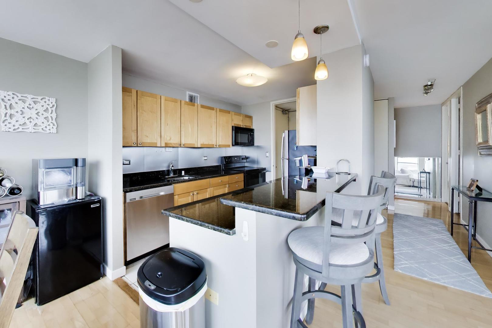 655 West Irving Park Road, Unit 2302 Chicago, IL 60613 - Photo 14 of 41 a living room with furniture and a wooden floor
