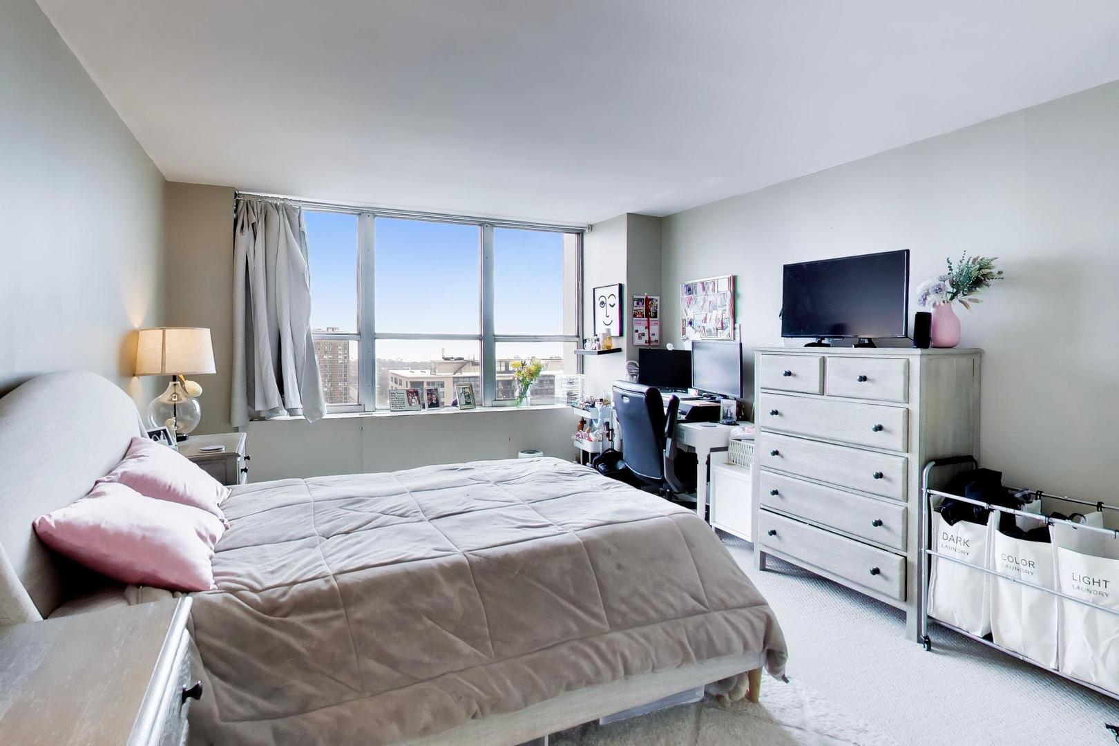 655 West Irving Park Road, Unit 2302 Chicago, IL 60613 - Photo 16 of 41 a bedroom with a bed and a flat screen tv