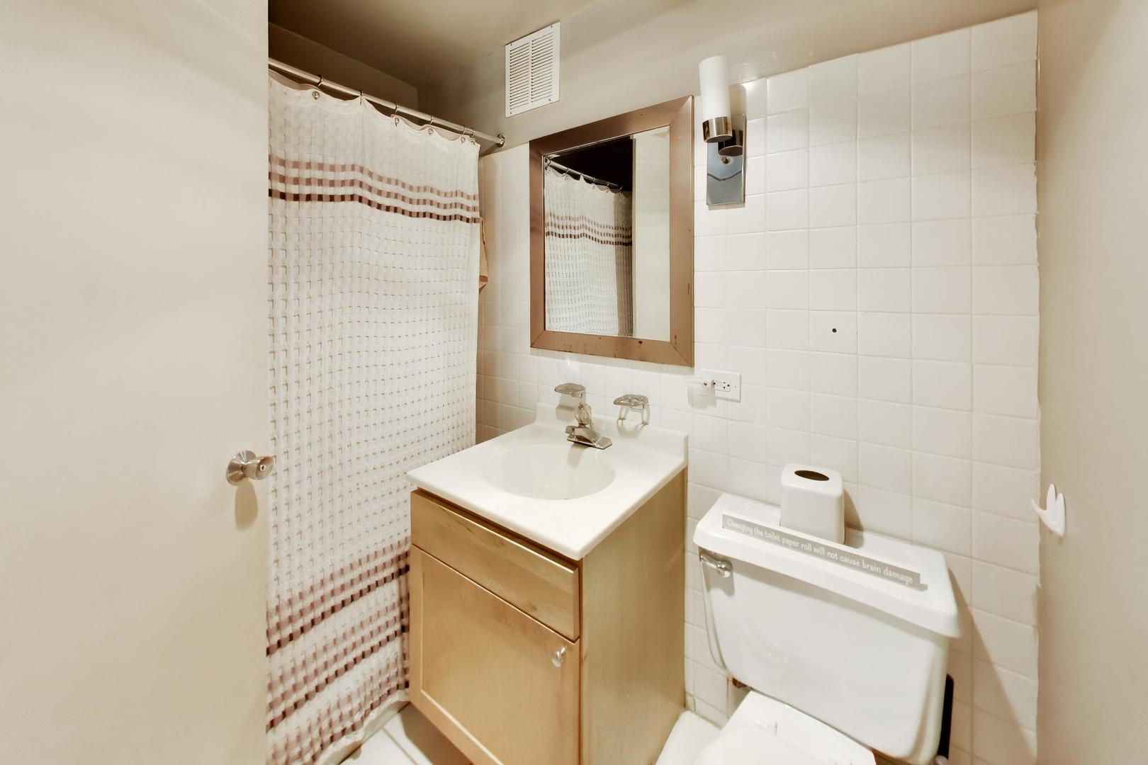 655 West Irving Park Road, Unit 2302 Chicago, IL 60613 - Photo 19 of 41 a bathroom with a sink toilet vanity and shower