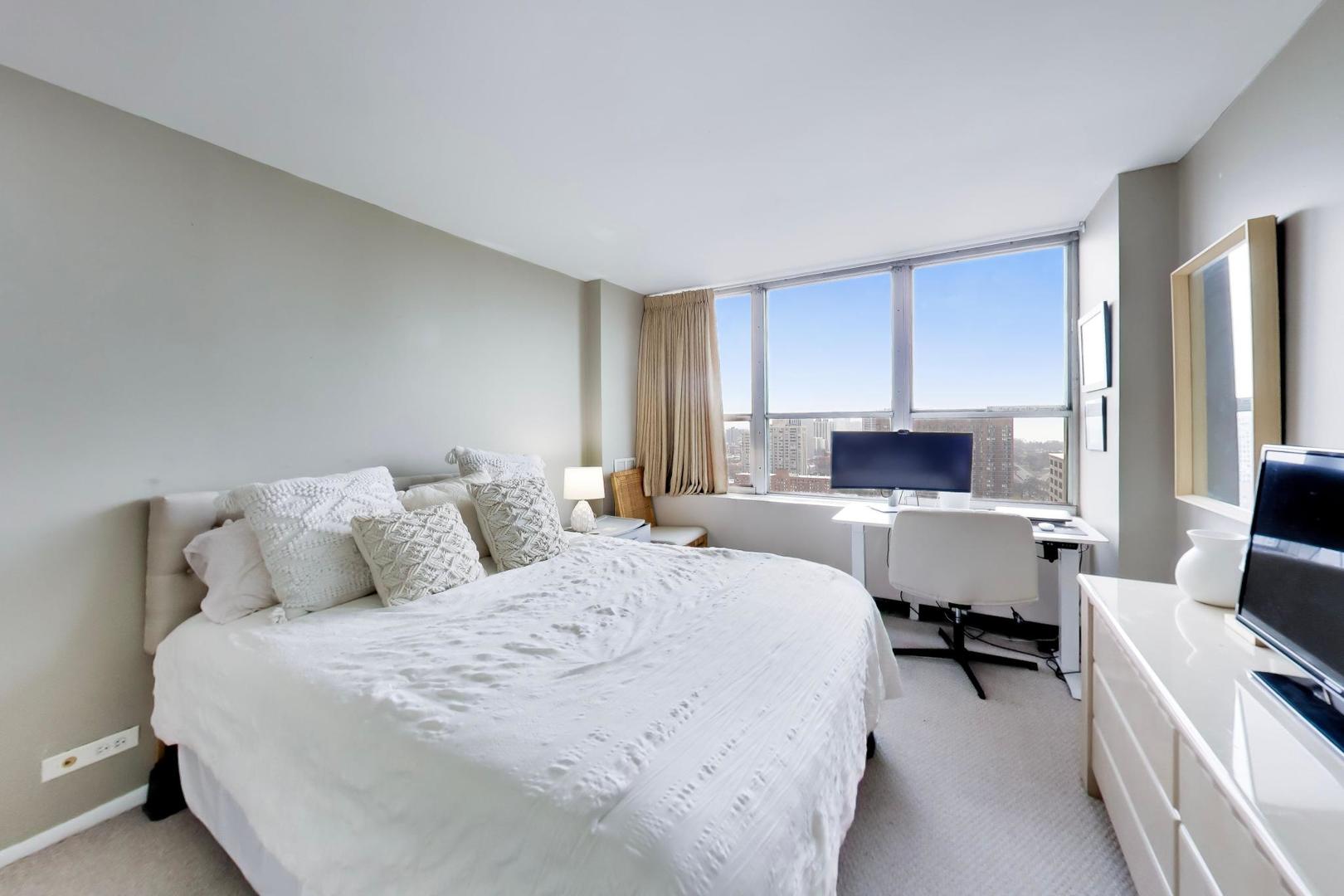655 West Irving Park Road, Unit 2302 Chicago, IL 60613 - Photo 20 of 41 a bedroom with a bed a computer on desk and a chair