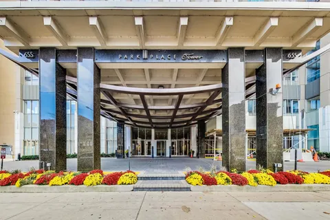a view of yellow house with swimming pool in front of it