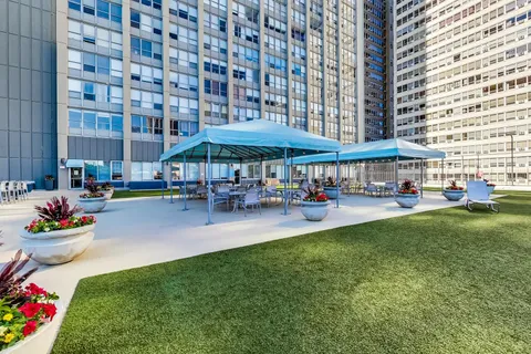 a view of a chair and table in the backyard